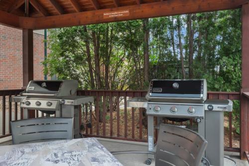 two bbqs and a grill on a patio at Candlewood Suites La Crosse by IHG in La Crosse
