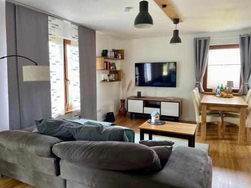 a living room with a couch and a table at Ferienhaus Ella in Trautskirchen
