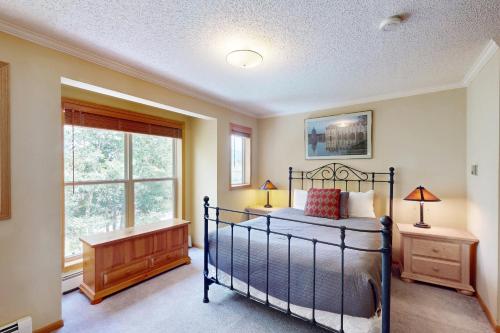 a bedroom with a bed and a window at Saddle Ridge Townhome 402 in Silverthorne