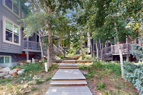 a walkway in front of a building with trees at Saddle Ridge Townhome 402 in Silverthorne