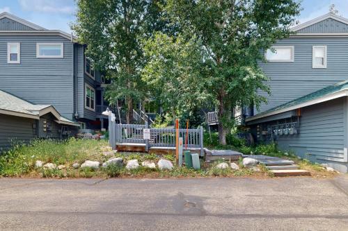 a yard with a bench in front of a house at Saddle Ridge Townhome 402 in Silverthorne