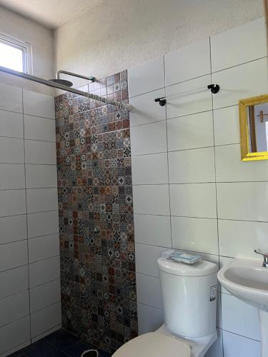 a bathroom with a toilet and a sink at Peaceful Room in Malucano