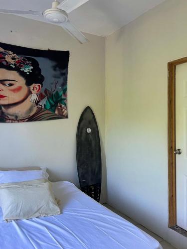 a bedroom with a bed and a painting on the wall at Peaceful Room in Malucano