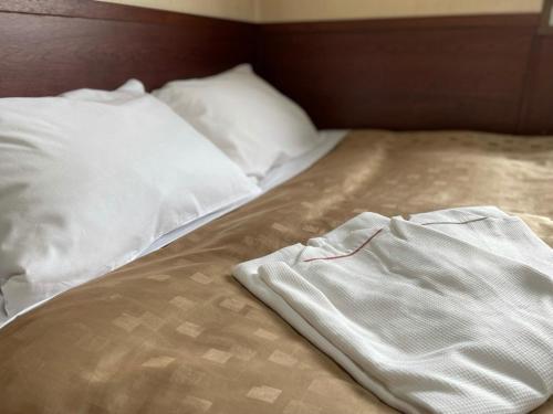 a bed with a pair of white clothes on it at Fuji Park Hotel - Vacation STAY 23854v in Fuji