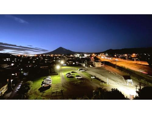 a city at night with cars parked in a parking lot at Fuji Park Hotel - Vacation STAY 23861v in Fuji