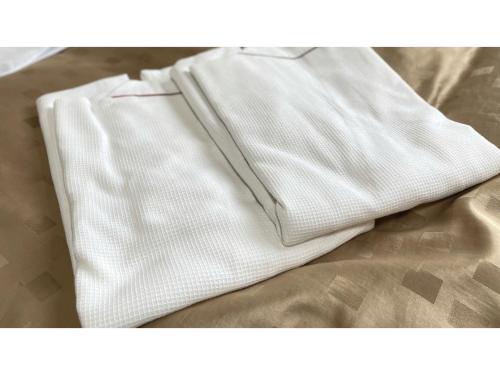 a pair of white pants sitting on top of a bed at Fuji Park Hotel - Vacation STAY 23861v in Fuji