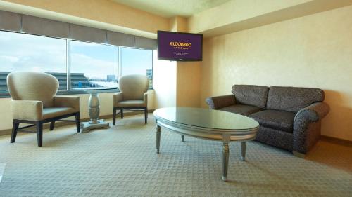 a waiting room with a couch and a table and chairs at Eldorado Reno, A Caesars Destination in Reno