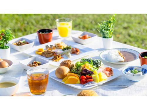 a table with plates of food and drinks on it at Goto Conkana Kingdom - Vacation STAY 25614v in Goto
