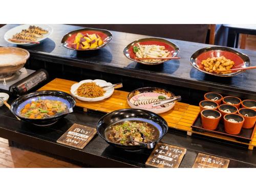 a buffet with bowls of food on a table at Goto Conkana Kingdom - Vacation STAY 25614v in Goto