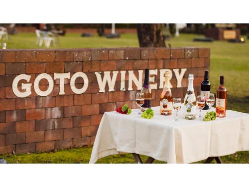 a table with wine bottles and glasses on it at Goto Conkana Kingdom - Vacation STAY 25614v in Goto