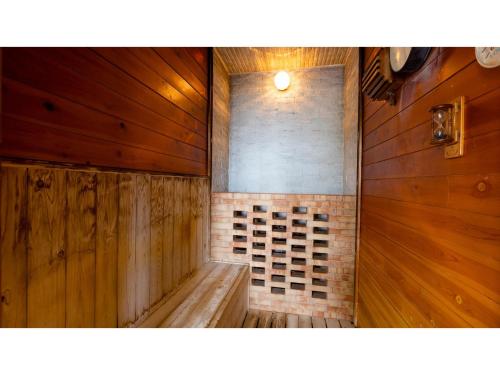 a sauna with wooden walls and a wooden bench at Goto Conkana Kingdom - Vacation STAY 29692v in Goto