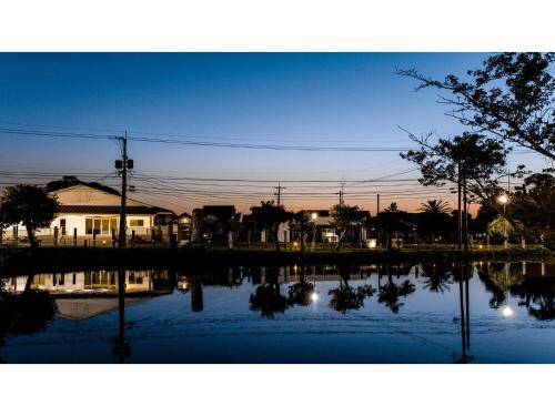 a reflection of a house in a body of water at Goto Conkana Kingdom - Vacation STAY 29692v in Goto
