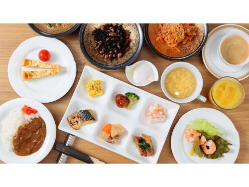 a table with plates of food and bowls of food at Hotel Flags Isahaya - Vacation STAY 25620v in Isahaya