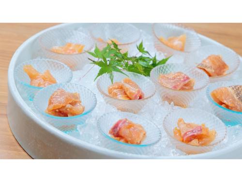 a plate of small cups of food on a table at Hotel Flags Isahaya - Vacation STAY 25620v in Isahaya