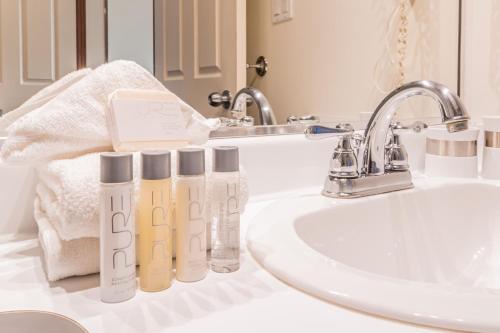 a bathroom counter with a sink and two bottles of shampoo at Alpenglow Lodge by Elevate Vacations in Whistler