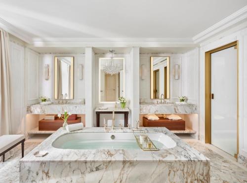a large bathroom with a tub and two sinks at Mandarin Oriental Ritz, Madrid in Madrid