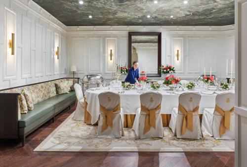 a woman standing in front of a table in a room at Mandarin Oriental Ritz, Madrid in Madrid
