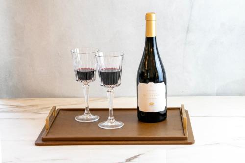 a bottle of wine and two glasses on a tray at Mandarin Oriental Ritz, Madrid in Madrid