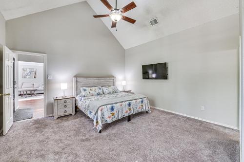 a bedroom with a bed and a ceiling fan at 10 Mi to Lake Lewisville Carrollton Home with Pool in Carrollton