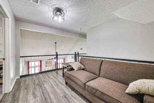 a living room with a couch and a balcony at 10 Mi to Lake Lewisville Carrollton Home with Pool in Carrollton