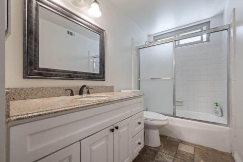 a bathroom with a sink and a toilet and a mirror at Elm Mountain View Fire pit, quiet and more in Los Angeles