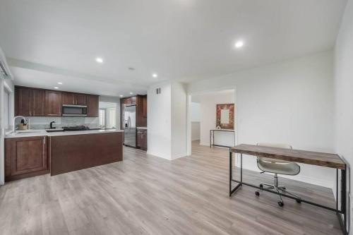 a kitchen with a table and a chair in a room at Elm Mountain View Fire pit, quiet and more in Los Angeles