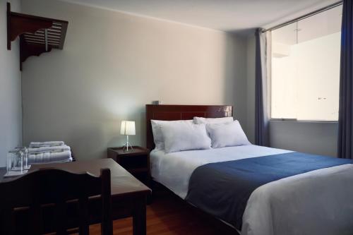 a bedroom with a large bed and a window at Colca Canyon Hotel by PERU HTL in Chivay