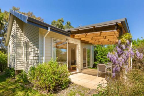 a home with a patio with a pergola at Estuary Escape Mapua in Mapua