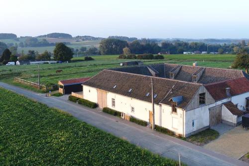 an overhead view of a house with a road at Square Shaped Farmhouse from 1713 in Nieuwenhove