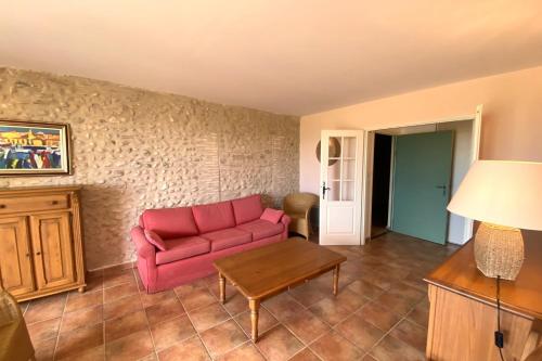a living room with a red couch and a table at 04B3 Beautiful T3 in the heart of lavender - pool in Brunet