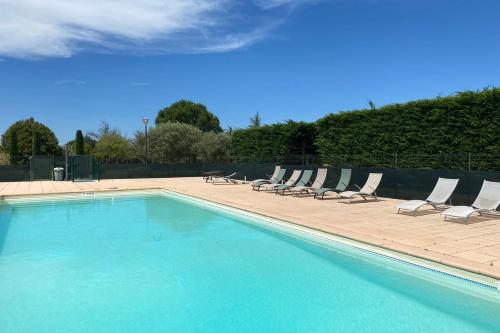 a swimming pool with lounge chairs and a swimming pool at 04B3 Beautiful T3 in the heart of lavender - pool in Brunet