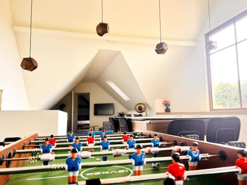 a group of lego figurines in a room with tables and chairs at Square Shaped Farmhouse from 1713 in Nieuwenhove
