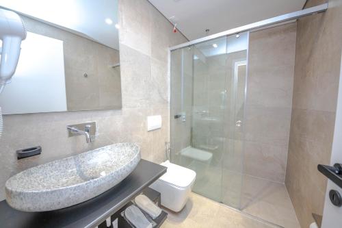 a bathroom with a sink and a toilet and a shower at Hotel Vista Mare in Ksamil