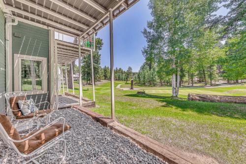 a porch of a house with chairs and a yard at Cloudcroft Townhome on Golf Course with Deck! in Cloudcroft
