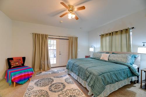 a bedroom with a bed and a ceiling fan at Spacious Grants Pass Home with Hot Tub and River Views in Grants Pass