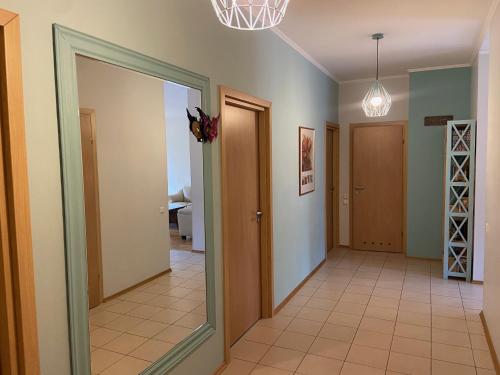 a hallway with a door leading to a room at Imanta Hidden Gem self check in in Rīga