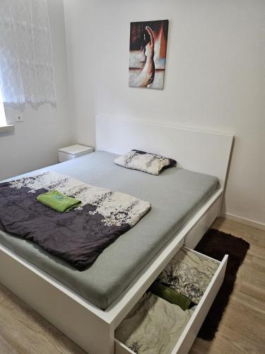 a bed in a room with avertisementatronatronstrationstrationstration at Kauno apartamentai king size bed in Kaunas