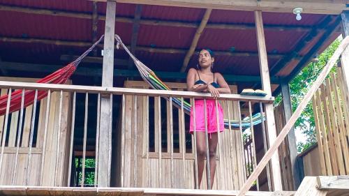 a girl standing on a porch in a hammock at Posada Brisas del Cachcal in Panguí