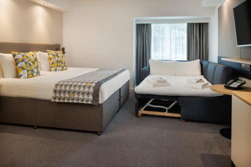 a hotel room with two beds and a tv at Holiday Inn South Normanton M1, Jct.28 by IHG in South Normanton
