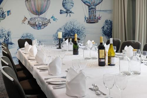 a long table with wine bottles and glasses on it at Holiday Inn South Normanton M1, Jct.28 by IHG in South Normanton