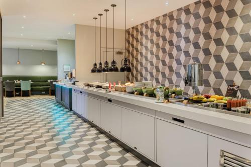 a kitchen with a counter with fruits on it at Holiday Inn South Normanton M1, Jct.28 by IHG in South Normanton