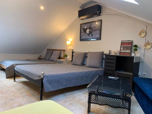 a living room with two beds and a couch at Roses Apartments in Néa Michanióna