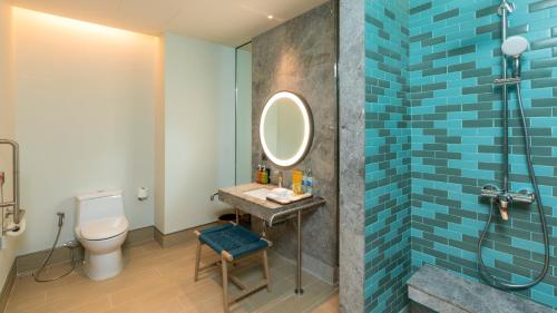 a bathroom with a toilet and a sink and a mirror at Holiday Inn Resort Samui Bophut Beach by IHG in Bophut 