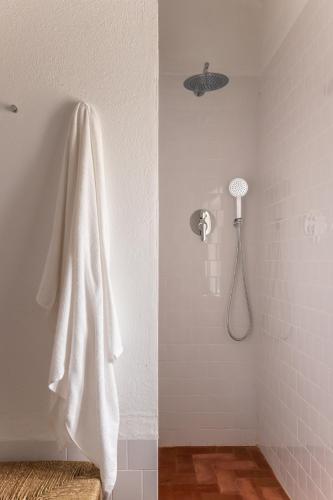 a bathroom with a shower with a white towel at Monte dos Coureleiros in Castelo de Vide