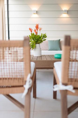 a living room with a table and chairs and a couch at Hill Rock villas - Blue Silver in Petit-Bourg