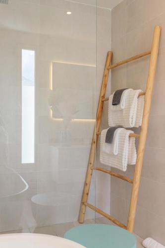 a towel rack in a bathroom with white towels at Hill Rock villas - Blue Silver in Petit-Bourg