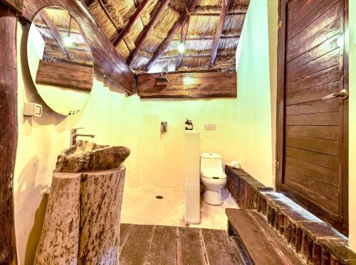a bathroom with a sink and a toilet at Alquimia Hotel Boutique in Tulum