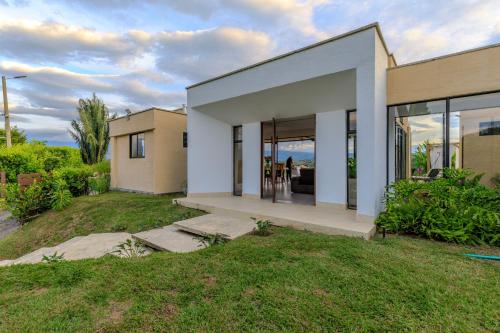 a rendering of a house with glass doors at Casa Río Quindío in La Tebaida