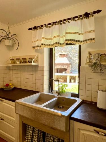 a kitchen with a sink and a window at Ciborovi Dvori in Bribir