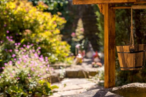 a garden with colorful flowers and a hanging basket at Broadway Scandi Chic Authentic Cottage in Broadway
